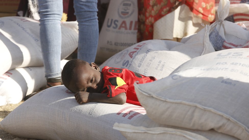 Tigray people, fled due to conflicts and taking shelter in Mekelle city of the Tigray region, in northern Ethiopia, receive the food aid distributed by United States Agency for International Development (USAID) on March 8, 2021.