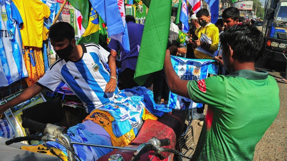 A street vendor selling fake Brazil and Argentina shirts in Dhaka, Bangladesh