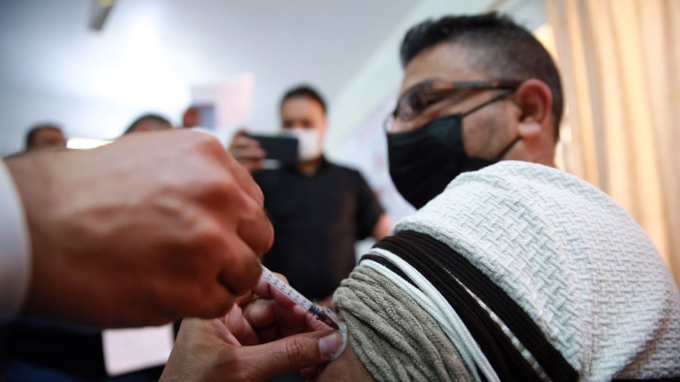 عاملون صحيون يتلقون لقاح فيروس كورونا خلال حملة تطعيم في بغداد، العراق