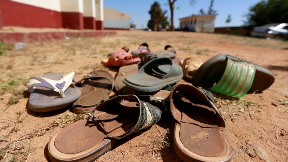Sandals sit in the dirt following an attack on a Nigerian school