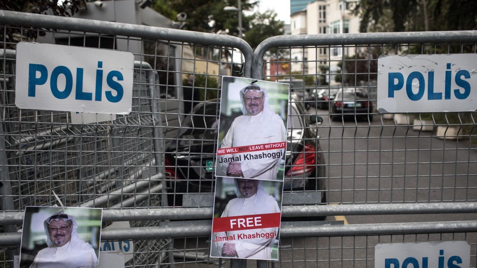 Posters of Saudi journalist Jamal Khashoggi are seen stuck to a police barricade in front of Saudi Arabia's consulate on October 8, 2018 in Istanbul, Turkey.