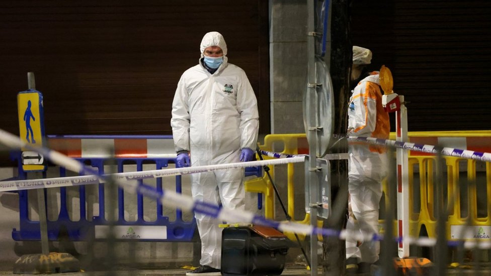 Belgian police officers search for evidence after two people were killed during a shooting in Brussels