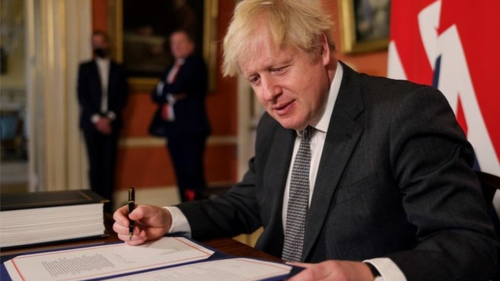 Boris Johnson signing the trade deal