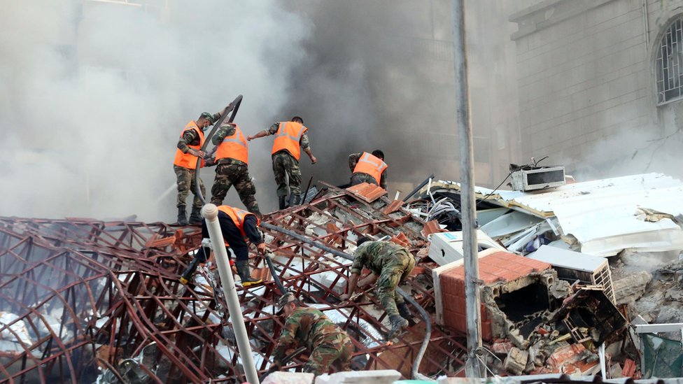 Rescue workers at the site of an airstrike in Damascus, Syria, in April this year