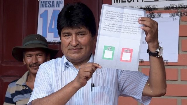 Bolivia's President Evo Morales holds a ballot paper