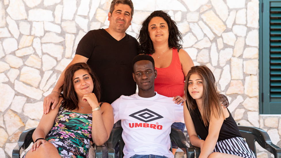 Muhammed "Lexy" Sanneh (centre) surrounded by the Ferraro family