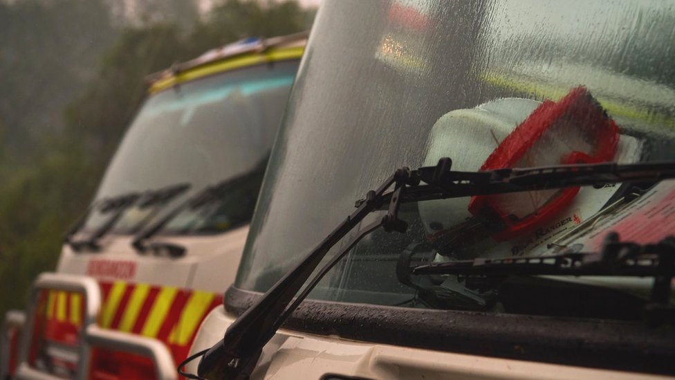 Fire trucks with rain on the windshields