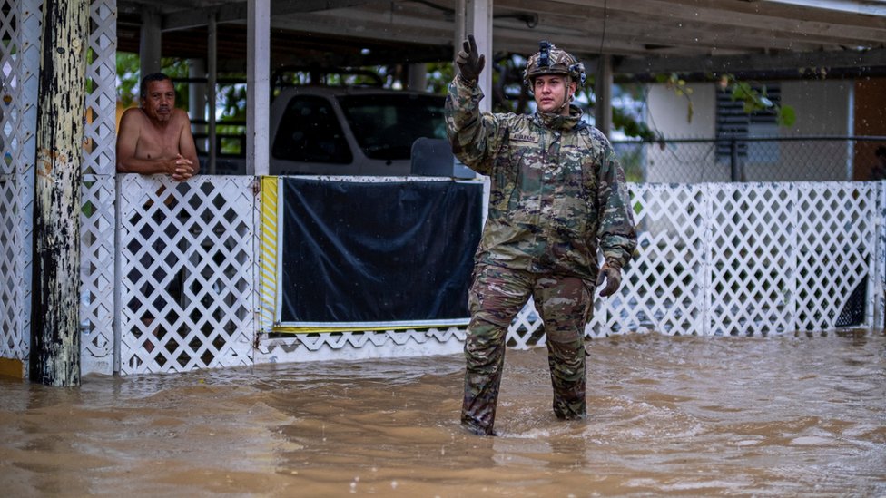 Soldier standing in a flooded area in Puerto Rico.