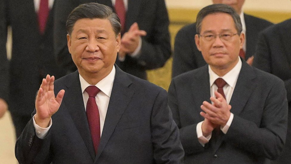 China's leader Xi Jinping walks with members of the Chinese Communist Party's new Politburo Standing Committee, the nation's top decision-making body, including Li Qiang.