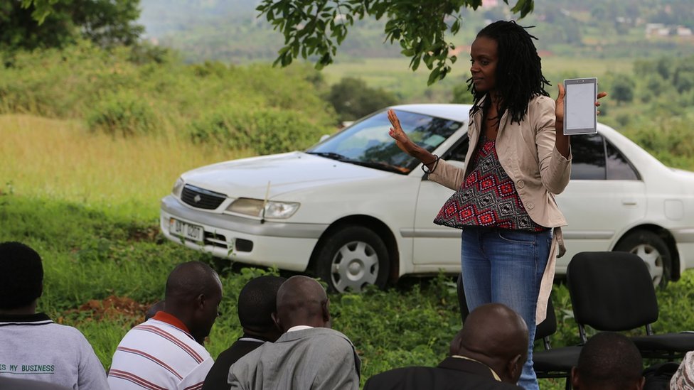 Catherine Nakalembe talking to a group of men