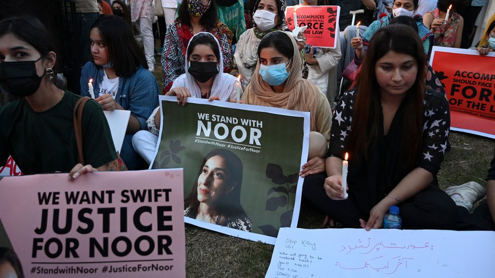 Women rights activists hold placards and candles during a protest rally against the brutal killing of Noor Mukadam, the daughter of a former Pakistani diplomat who was found murdered at a house in Pakistan`s capital on July 20, in Islamabad on September 22, 2021.