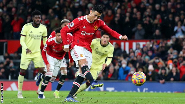 Manchester United's Cristiano Ronaldo scores a penalty against Arsenal in the Premier League