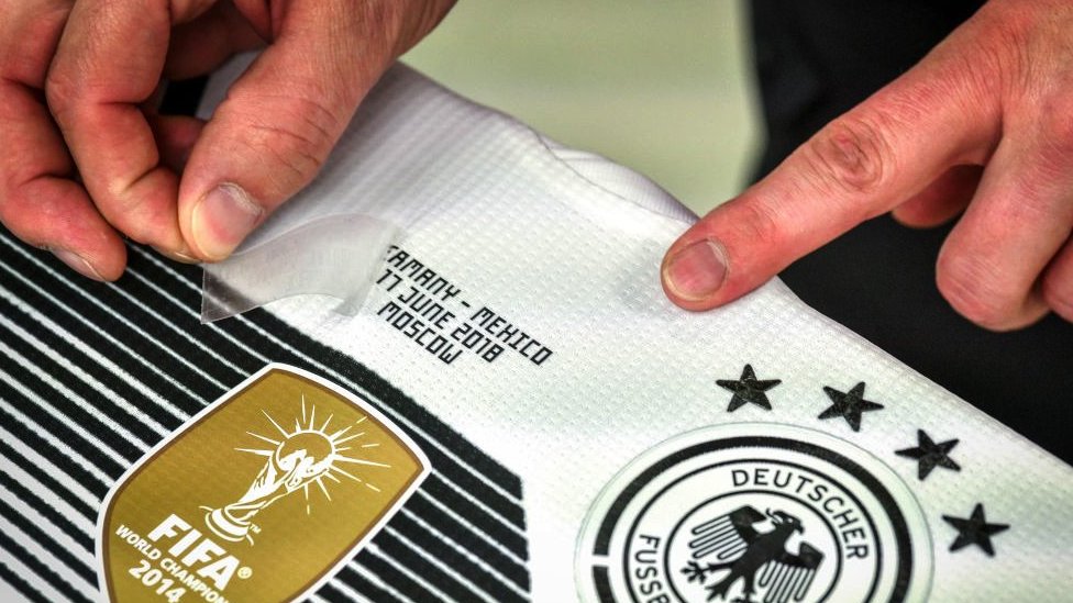 A Germany shirt being customised in an Adidas factory