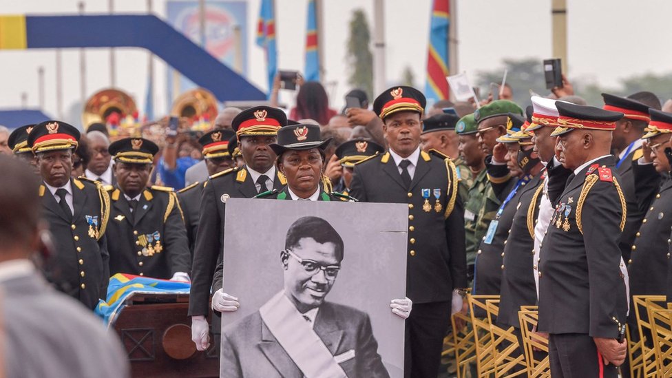 The procession carrying slain Congolese independence hero Patrice Lumumba's only surviving remains arrives at the Limete Tower in Kinshasa on June 30, 2022. -