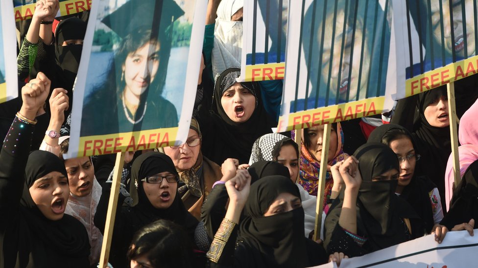 Пакистанские протестующие несут портреты Аафии Сиддики, пакистанского ученого, отбывающего тюремный срок в США, в Пакистане, 2008 г.