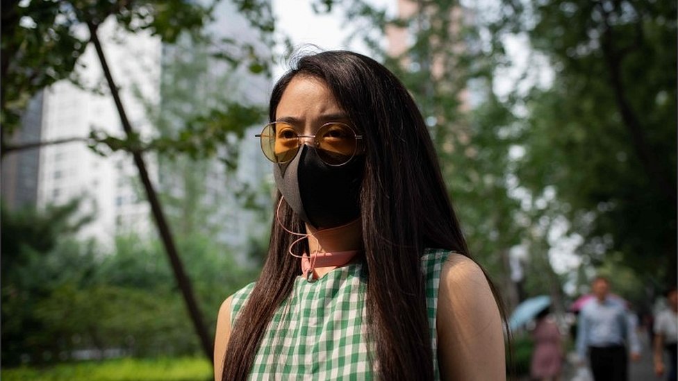 Женщина в защитной маске в Пекине