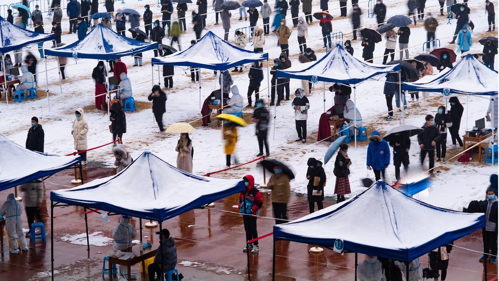 Aerial view of students and teachers queuing up for COVID-19 nucleic acid testing at Northwestern Polytechnical University during a snowfall on December 25 2021 in Xi an, Shaanxi Province of China