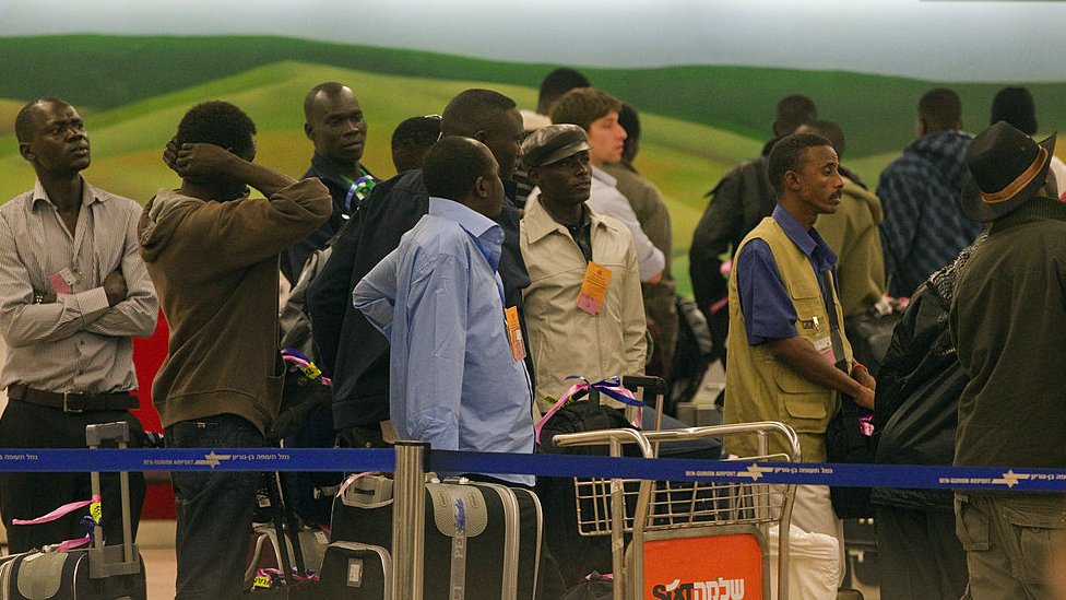 Some 150 refugees stand in line as they are sent back to Sudan on 13 December 2010 from the Ben Gurion Airport near Tel Aviv