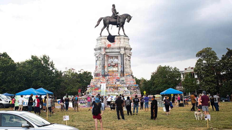 Protesters gather at a statue of Confederate Gen Robert E. Lee earlier this year