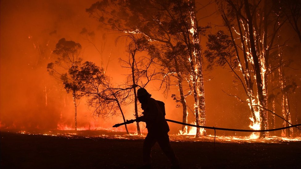 Firefighter in front of bushfire