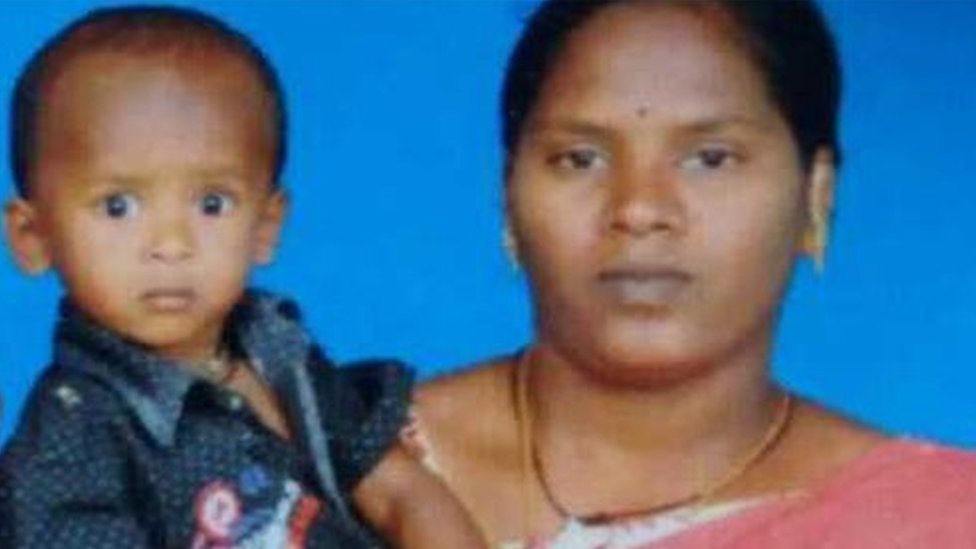 Sujith on his mother's arm with his brother and father