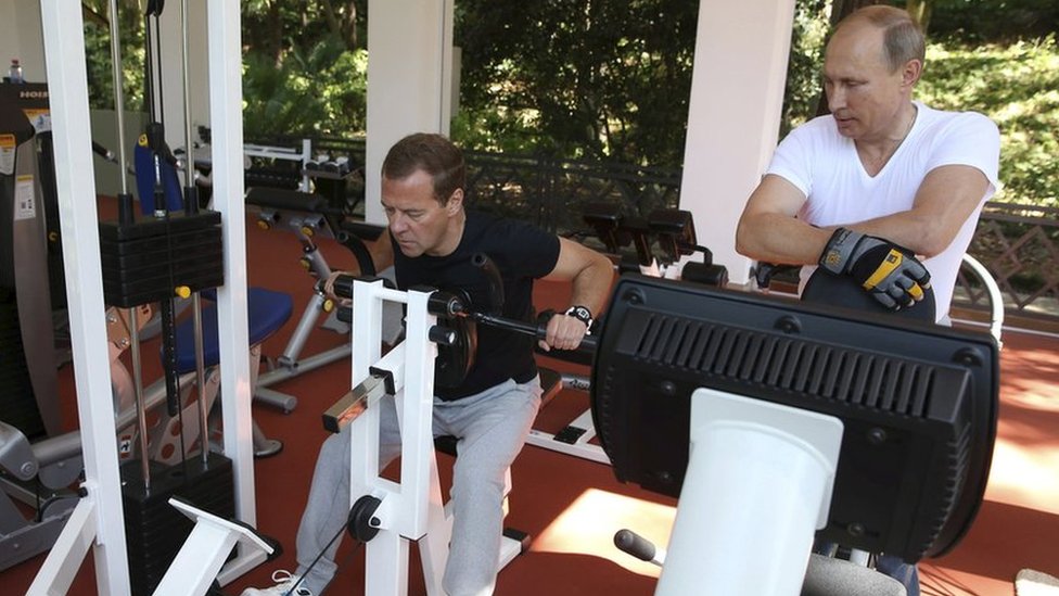 Russian President Vladimir Putin (R) and Prime Minister Dmitry Medvedev exercise in a gym at the Bocharov Ruchei state residence in Sochi, Russia, August 30, 2015.