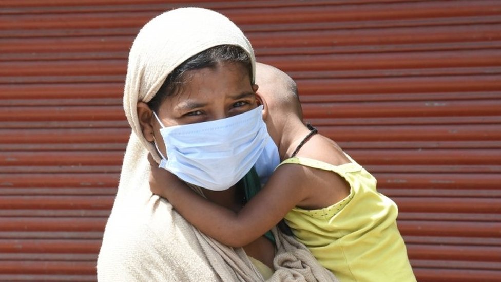 Woman and son wait for testing in Delhi, India. File photo
