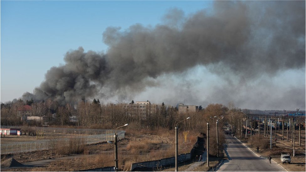 Smoke is seen above apartment blocks on March 18, 2022 in Lviv