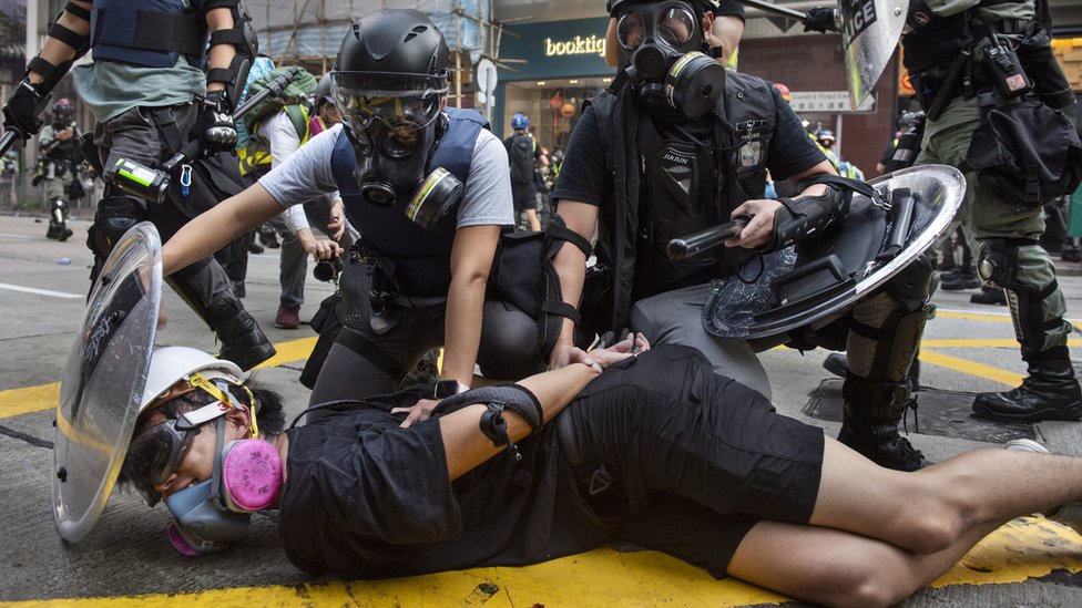 Полиция задерживает задержанного протестующего в Гонконге (1 октября 2019 г.)