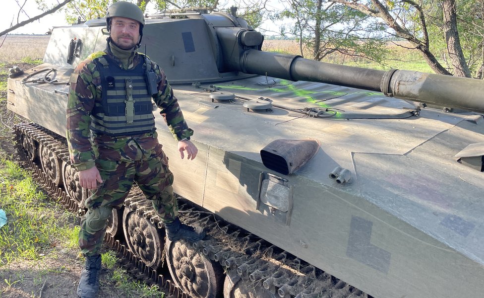 Stus, commander of the gunners standing next to the “Gvozdika” howitzer