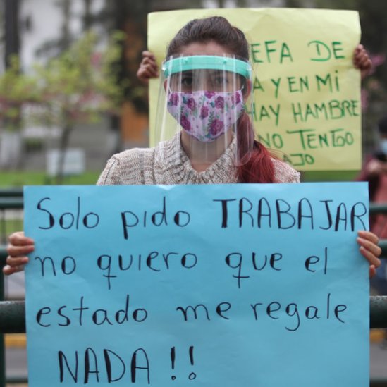 Mulher peruana segura cartaz pedindo que governo lhe permita trabalhar