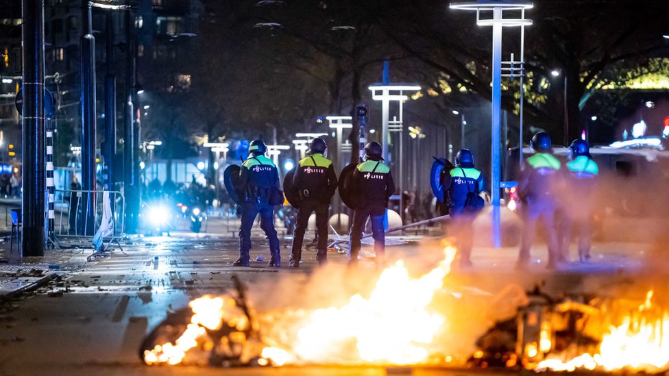 Policemen stand near burning objects after a protest against the "2G policy" turned into riots, with protesters setting fires in the street and destroying police cars and street furniture, Rotterdam, Netherlands, 19 November 2021. Hundreds of demonstrators gathered on Coolsingel earlier that evening because they disagree with the 2G policy, which refers to the two Dutch words for vaccinated and recovered. EPA/VLN NIEUWS