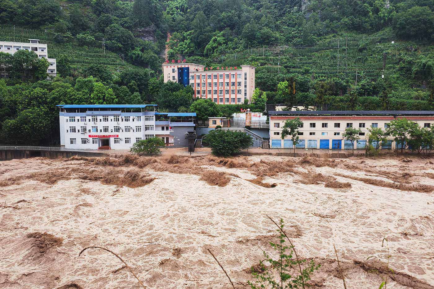 ​​River rages and bursts its banks after heavy rains in Wanzhou district in Chongqing - 4 July 2023