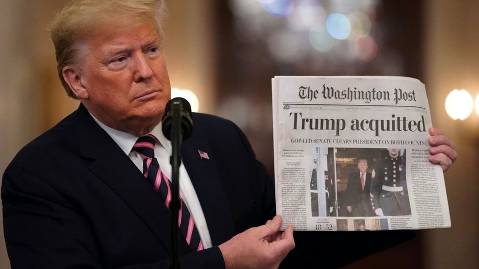 U.S. President Donald Trump holds a copy of The Washington Post with the headline 'Trump acquitted'Senate acquitted on February 6, 2020.