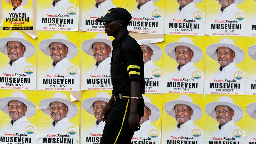 A man walks past elections posters of Uganda"s President Yoweri Museveni on a street in Kampala, Uganda January 12, 2021.