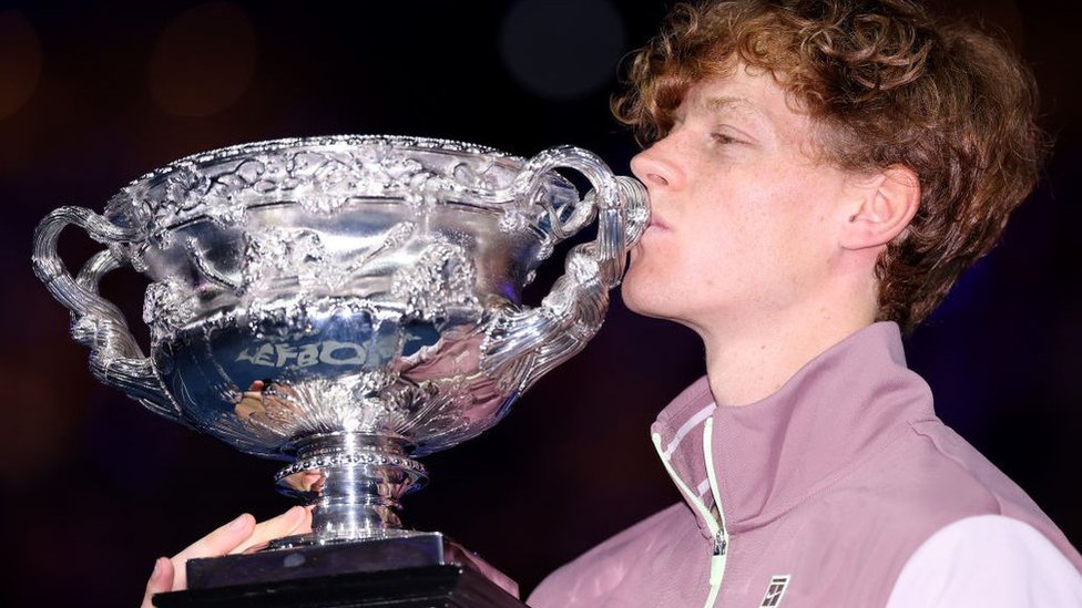 jannik sinner kisses the trophy