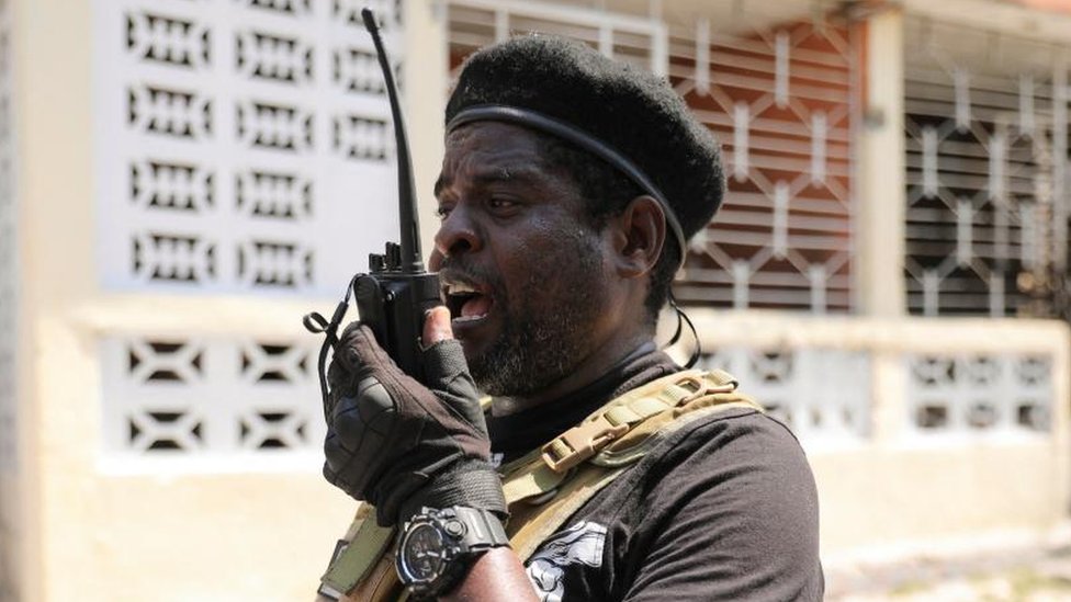 Former police officer Jimmy 'Barbecue' Cherizier, and leader of an alliance of armed groups, uses a walkie talkie after addressing the media, in Port-au-Prince, Haiti, 11 March 2024