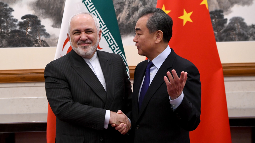 At a meeting in China in 2019, Foreign Minister Wang Yi shakes hands with Iran's Foreign Minister Mohammad Javad Zarif