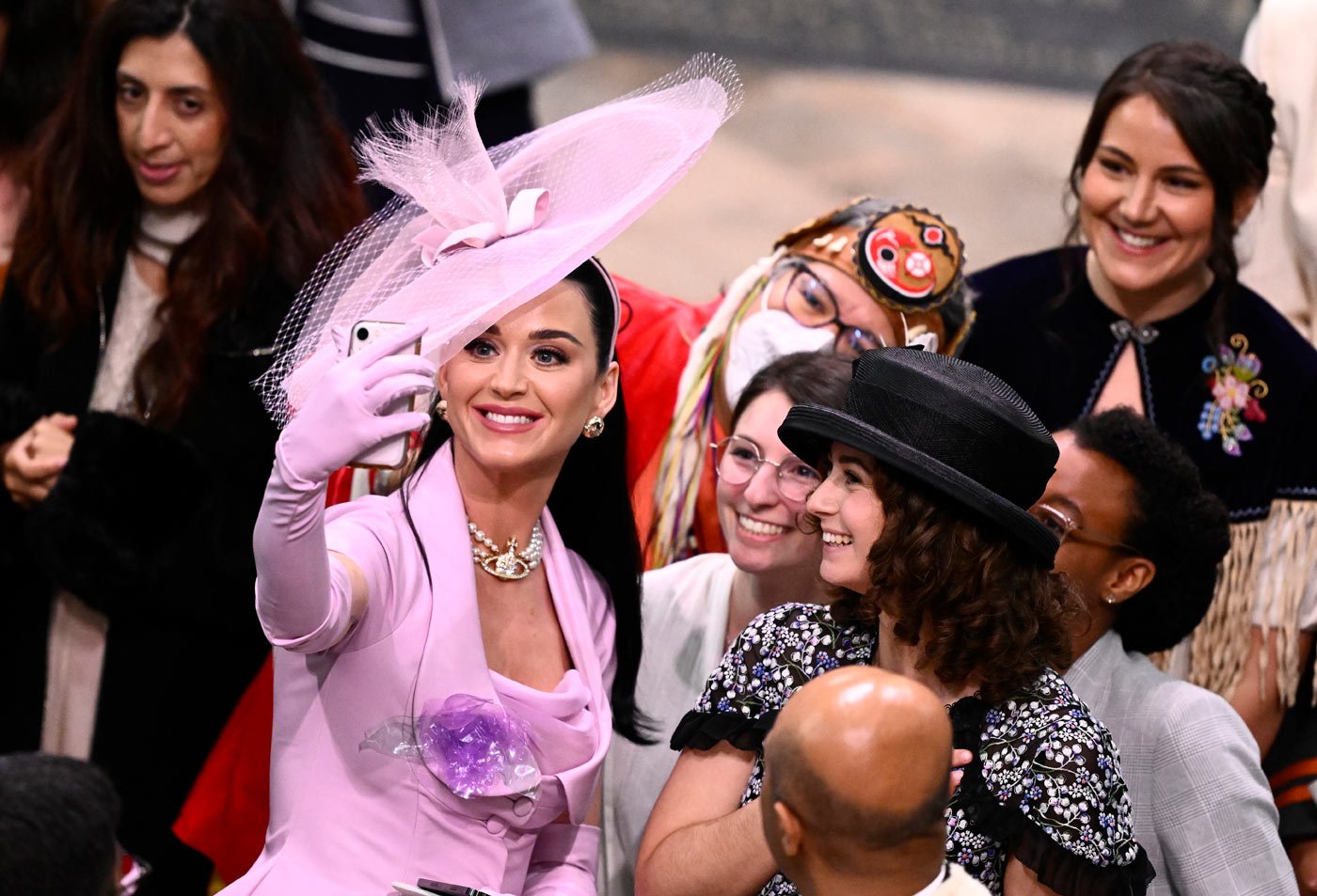 Katy Perry takes selfies with guests before the coronation ceremony