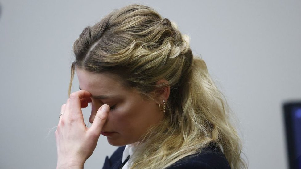Amber Heard reacts to an audio recording played in court