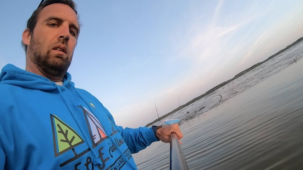 English storm. Paddleboarder.