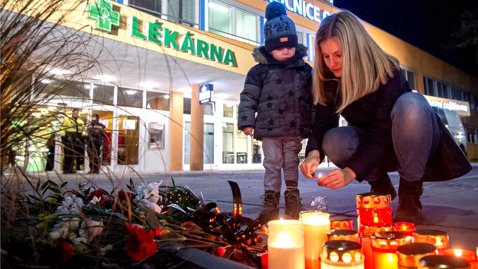 People light candles as they pay their respects for the victims of the shooting at a hospital in Ostrava, Czech Republic, 10 December 2019