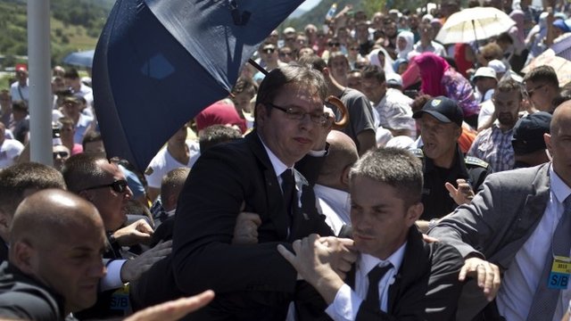 Aleksandar Vucic, Serbia"s prime minister, centre, is seen during a scuffle at the Potocari memorial complex near Srebrenica