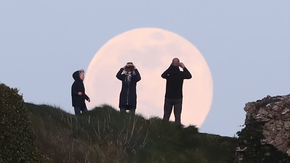 A pink supermoon rises over the Rock of Dunamase in County Laois in the Republic of Ireland