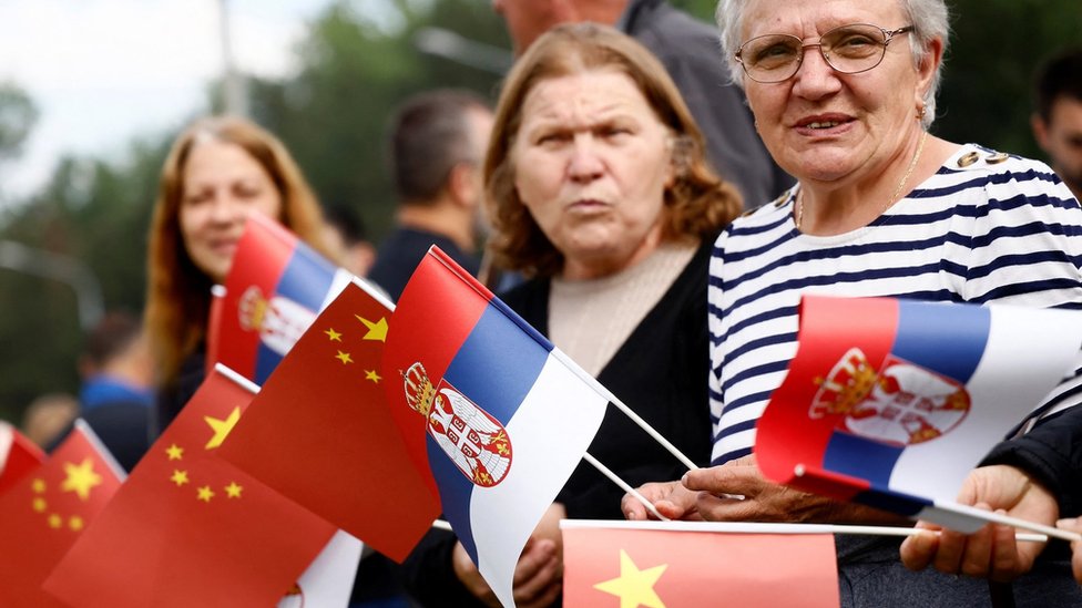 People waving Chinese and Serbian flags gather outside the Palace of Serbia during a welcome ceremony for Chinese President Xi Jinping in Belgrade, on May 8, 2024. Chinese President Xi Jinping will hold talks with his Serbian counterpart in Belgrade on May 8, 2024, as Beijing seeks to deepen its political and economic ties with friendlier countries in Europe