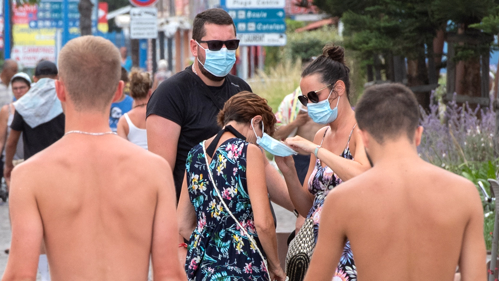 People adjust their masks in Argeles- sur-Mer, southern France