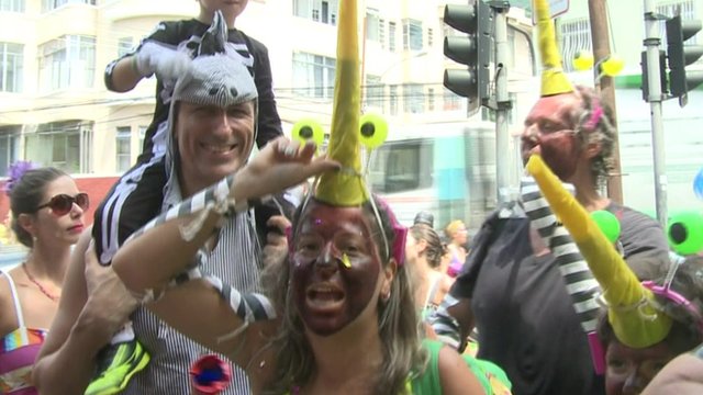Revellers at carnival, dressed at the Zika-carrying mosquito