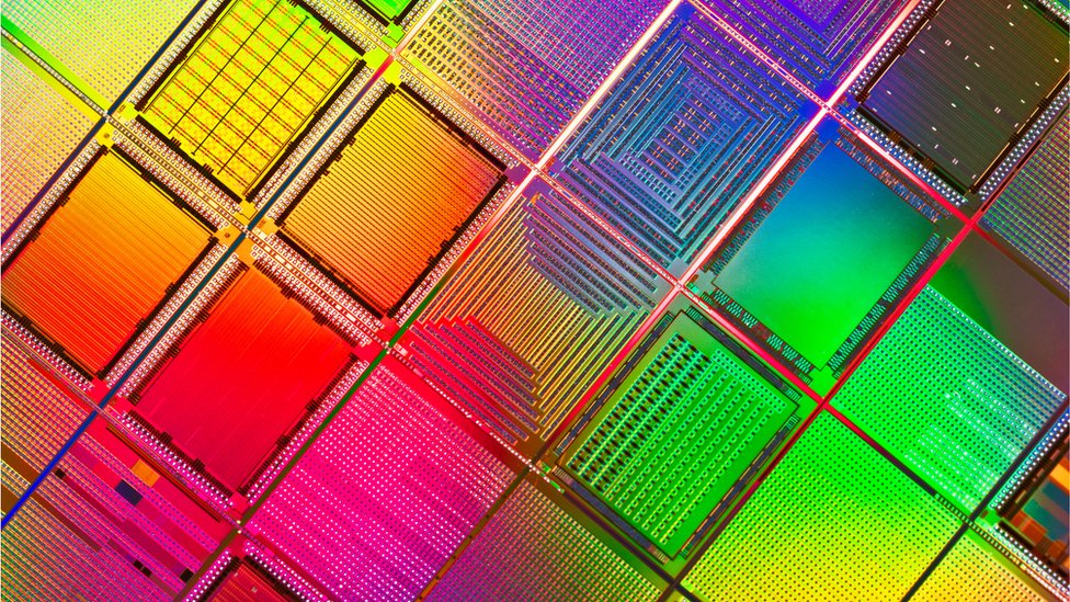 Silicon wafers are seen this extreme-close-up file photo, shimmering in a rainbow of colours