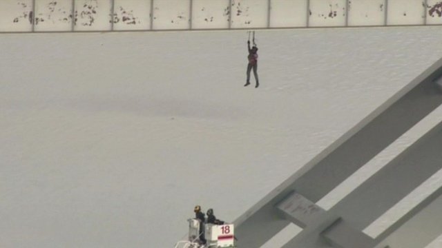 Construction worker dangling from a Houston bridge