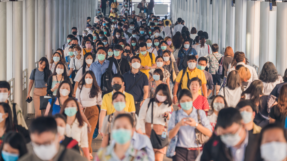 A large group of people wearing masks